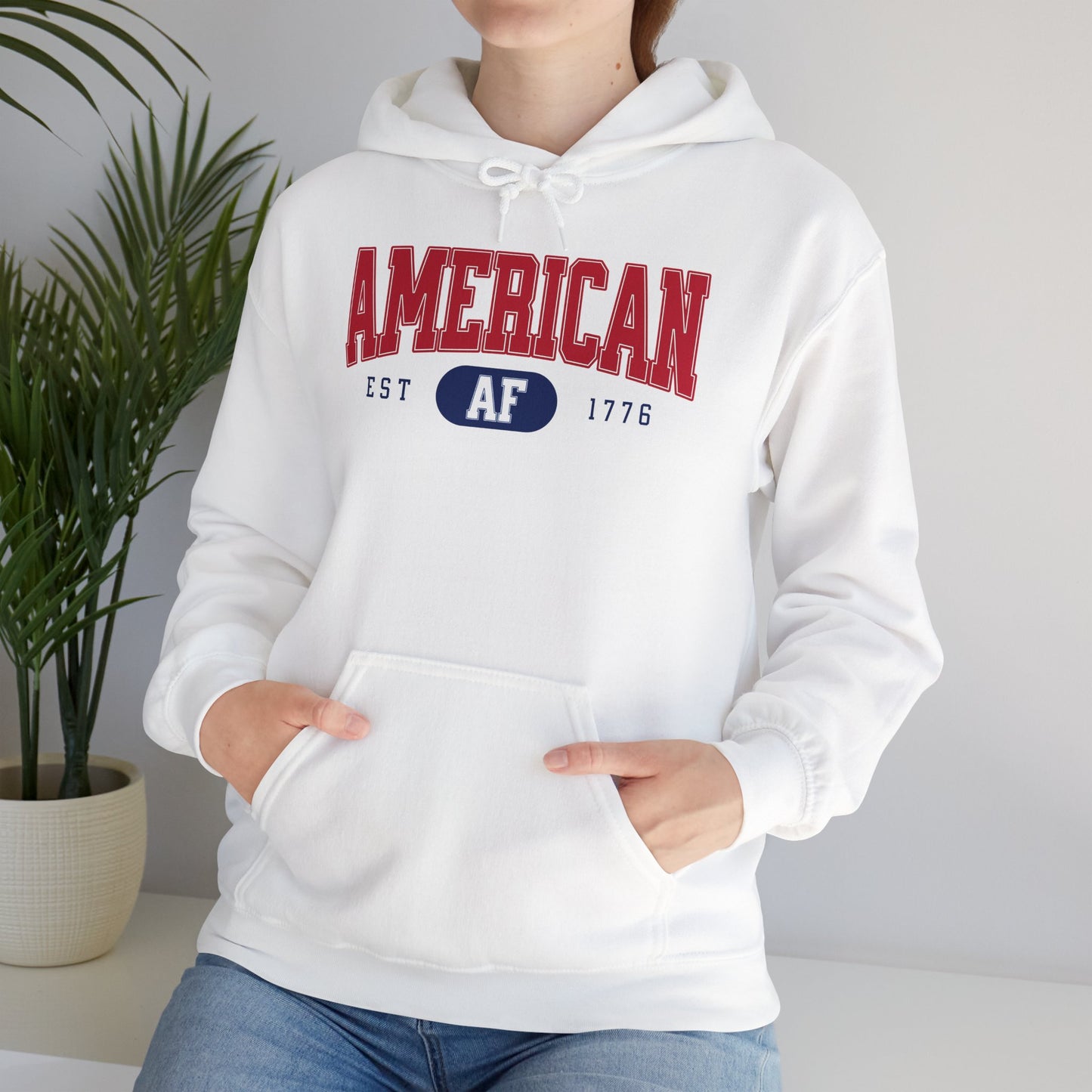 Woman leaning on desk wearing American AF sweatshirt